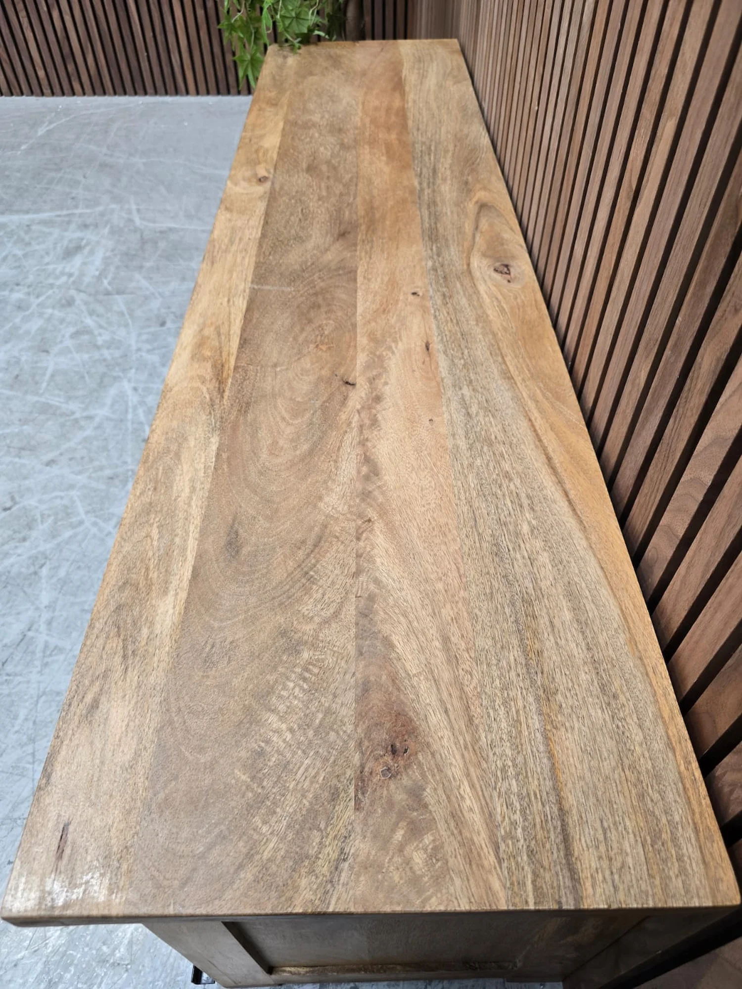 top of the tv stand showcasing the light mango wood grain