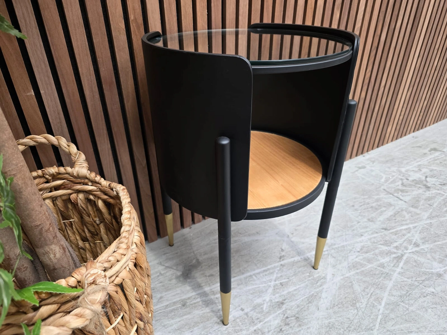 left side of the retro black metal and glass side table