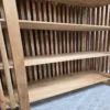 the bottom shelves on the bookshelf in light mango wood