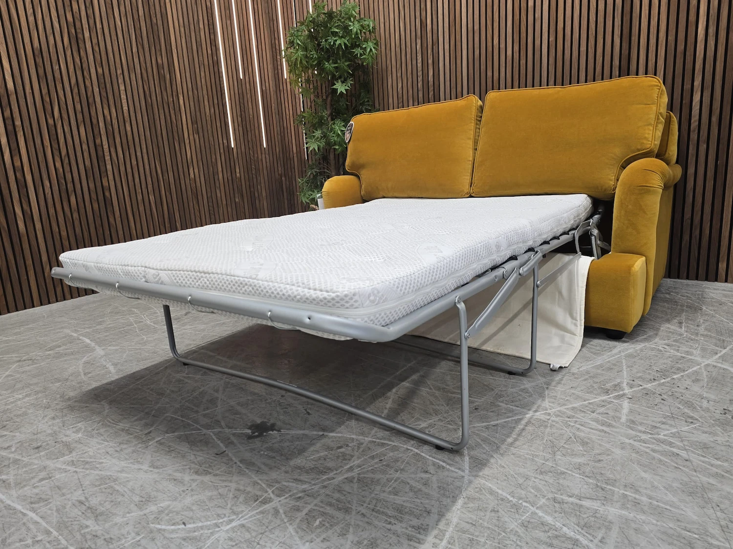 bluebell 2 seater sofa bed in amber smart velvet with the bed mechanism folded out from the right side