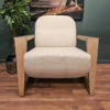 a light coloured chair with woodern arms and legs