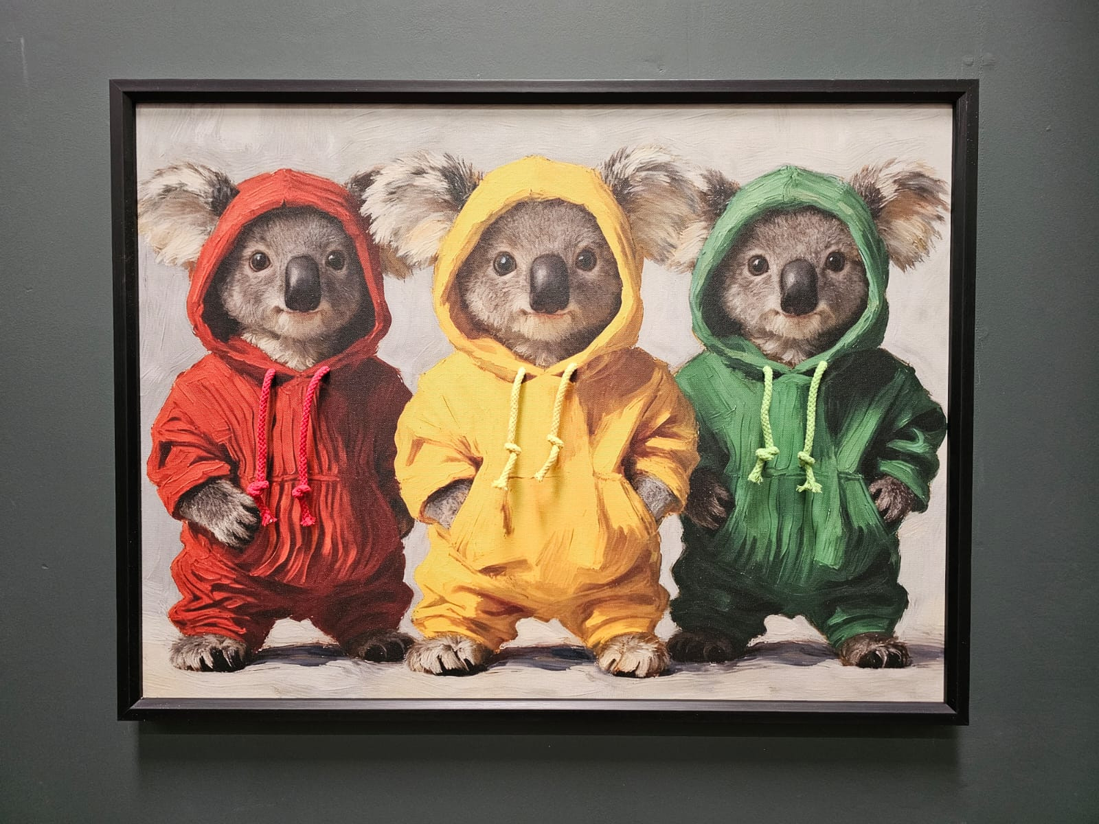a picture of three kolas in hoodies